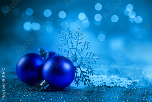 Blue christmas balls and snowflakes on bokeh background
