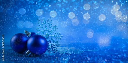 Blue christmas balls and snowflakes on bokeh background