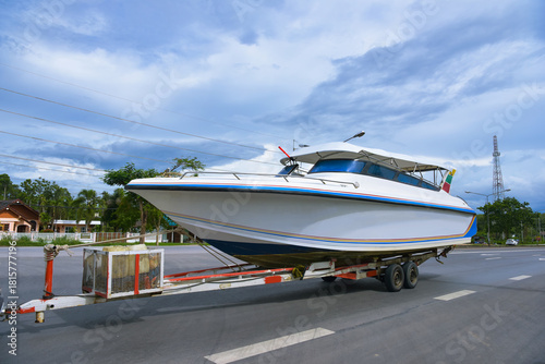 Speedboats and trailer hitch on road