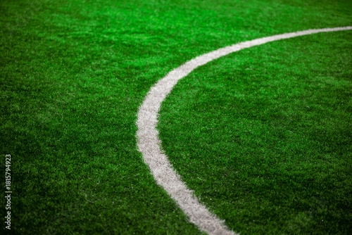 Photo of a green synthetic grass sports field with white line shot from above. 8K Resolution. Great to use as a background. Copy space image.