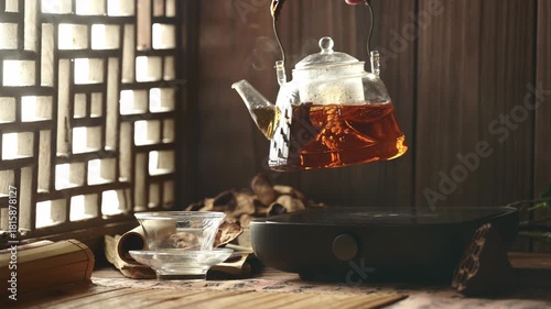 Glass Teapot Pouring Chenpi Tea into Cup - Traditional Chinese Herbal Health Tea Ceremony