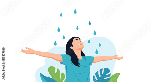A joyful young woman with her arms outstretched embraces the falling rain feeling a sense of freedom and pure happiness.
