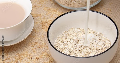 Bowl of Dry Oats Ready for Milk Pour Over to Make Healthy Breakfast Oatmeal on Wooden Table