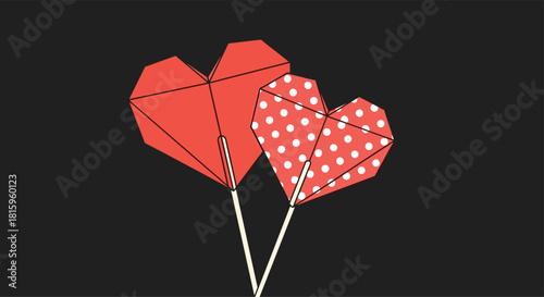 A romantic illustration of two red origami heart lollipops one solid and one with white polka dots against a dark background.