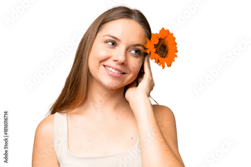 Obraz na płótnie Young blonde woman over isolated chroma key background holding a sunflower while smiling