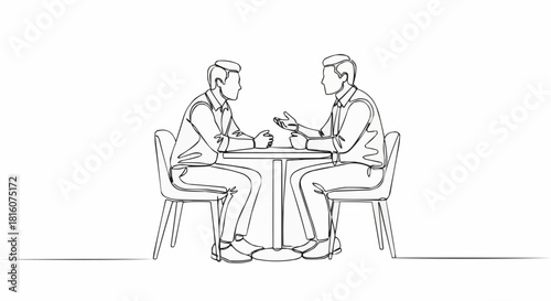 Two men sitting at a table discussing business matters.