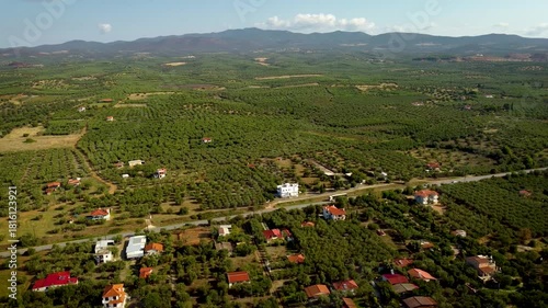 Aerial Drone View of Houses in Olive Groves with Highway Traffic in Gerakini, Greece