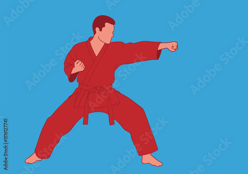 Karate fighter in red gi practicing punch on solid blue background