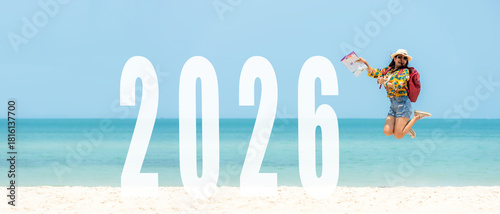Asian young woman happy  jumping congratulation and celebrate in Happy New year 2026 for change new life future concept. Freedom lifestyle jump as part of Number 2026 success on the sand beach outdoor