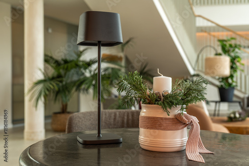 Cuadro en lienzo Christmas candle centerpiece with greenery in hotel lobby