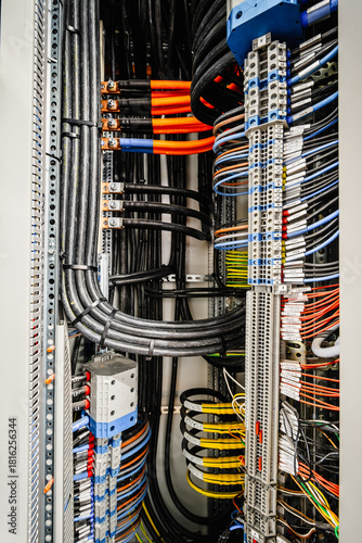 Close-up of industrial electrical installations and cable trays. Intricate network of power cables and wires for industrial or commercial infrastructure.