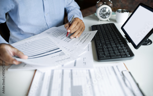 close up shot, asian businessman using digital tablet working and meeting online with documents checking business contract to making business plan