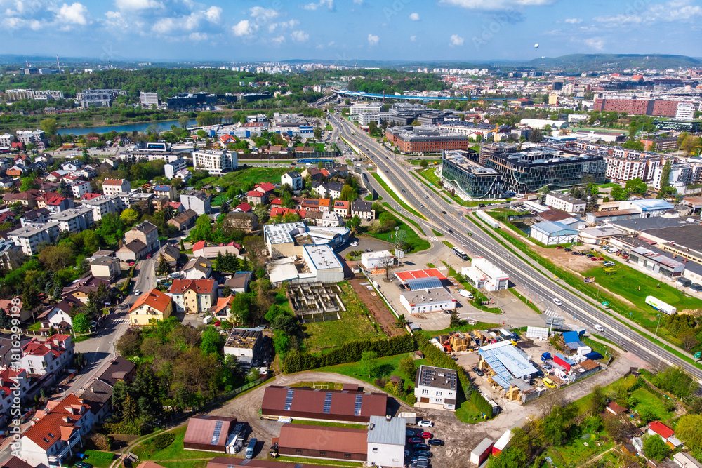 Obraz premium Aerial panorama of Krakow, Poland, showing the Podgórze district. View of the major Nowohucka road intersecting dense urban allotment gardens and residential areas.