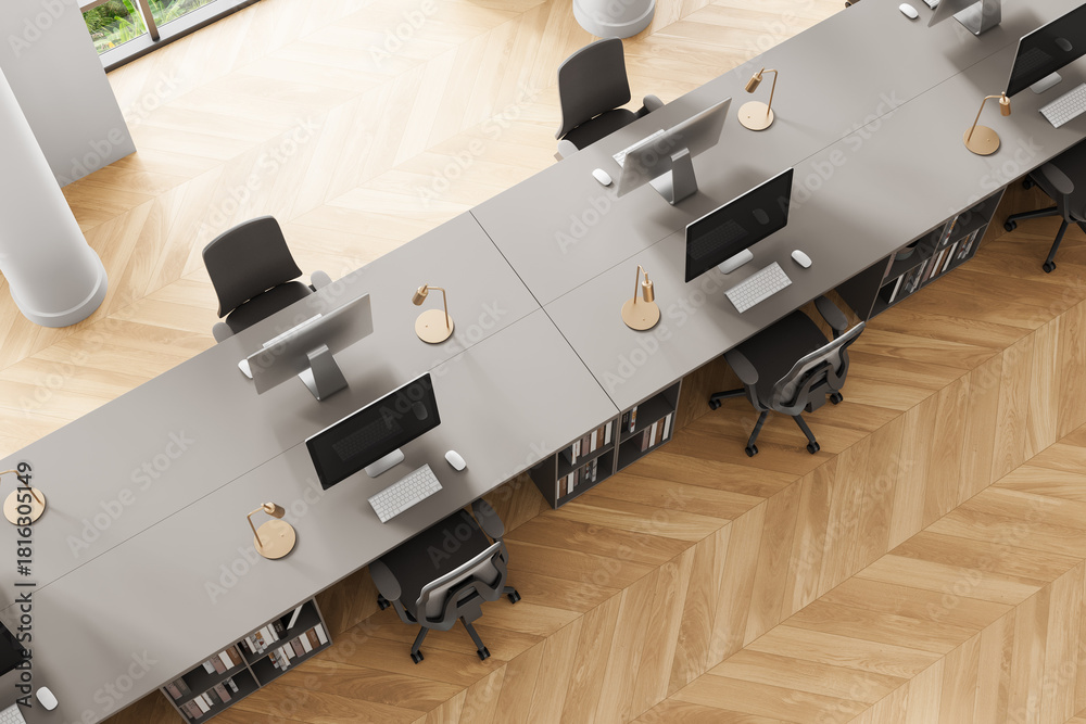 Obraz premium Top view of modern office interior with shared workstations, wooden floor, and minimalist design aesthetic in a bright workspace setting. 3D Rendering