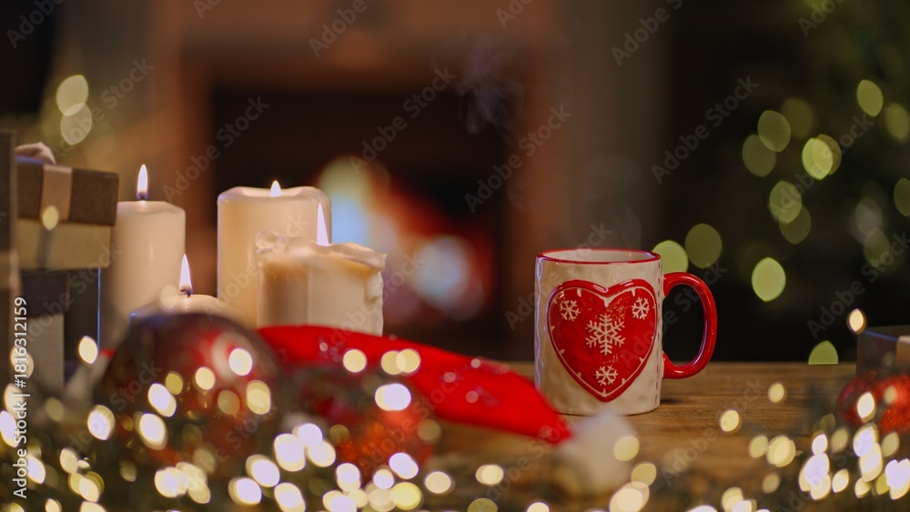 Obraz premium Still life of Christmas decoration and candle at home in cosy living room with fireplace. Winter holiday mood.
