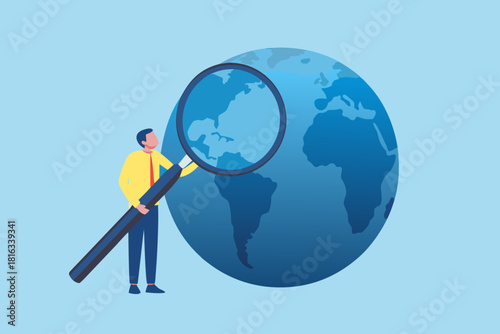 Man with magnifying glass examining globe exploring global issues and opportunities