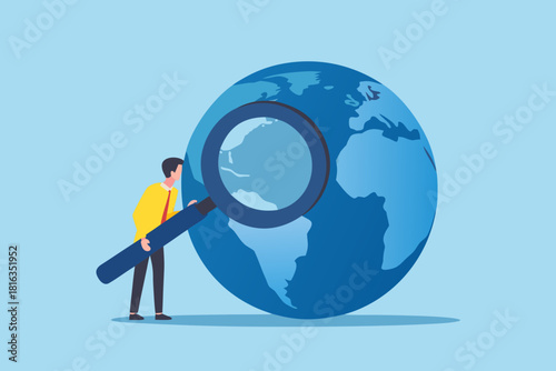 Global analysis businessman examining world with magnifying glass business strategy