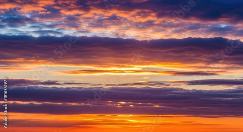 Vibrant Golden Hour Skyscape with Dramatic Orange and Purple Cloud Layers