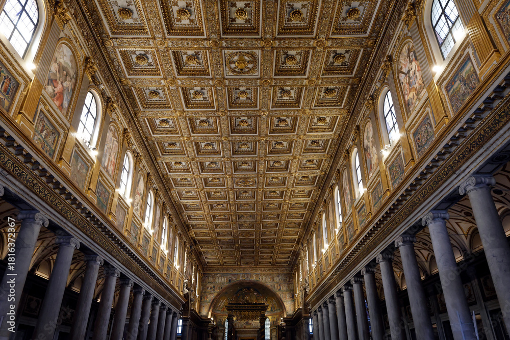 Fototapeta premium Ornate gilded coffered ceiling and luminous mosaics decorate the majestic nave of Santa Maria Maggiore Basilica.