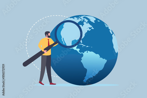 Man inspecting globe with magnifying glass global analysis and exploration concept