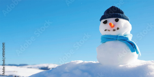Cheerful snowman standing against a clear blue sky in a winter snow scene