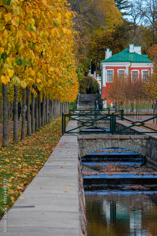 Obraz premium Trees are lining the walkway beside a canal in Kadriorg park in Tallinn, Estonia