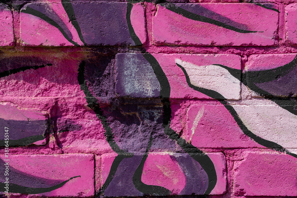 Fototapeta premium Wall work in the style of spray paint art covered with of different pink colors.
