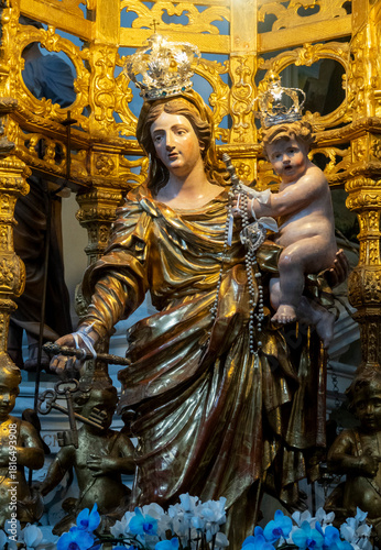 Statue (19th century) of Blessed Virgin Mary holding baby Jesus Christ in her arms.