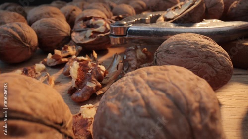Walnuts with nutcracker on wooden table close up.