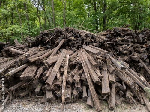 Old torn ripped out up railroad wooden railway railroad ties crossties sleepers wood lumber timber heap pile stack debris, decayed
