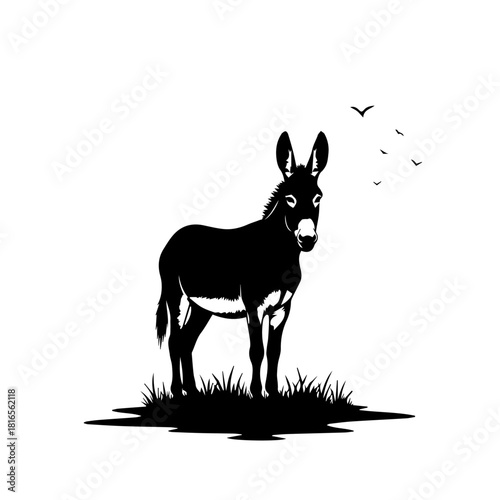 Black silhouette of a donkey standing on a grassy patch with birds flying in the background, isolated on white.