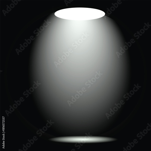 Empty stage illuminated by a bright white theatrical spotlight