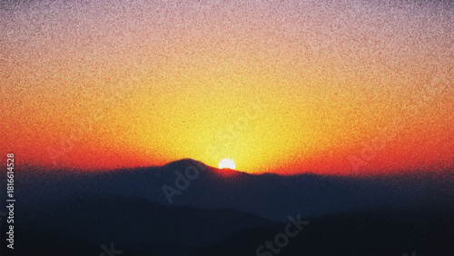 Dreamy grainy sunset above quiet mountain silhouettes with nostalgic analog film texture created from thousands of individual dots. Glowing sun settles behind hazy mountains with warm radiant colors