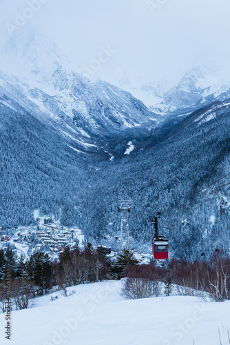 Red cable car in Dombai ski resort in Caucasus mountains in winter, Karachaevo-Cherkessiya, Russia