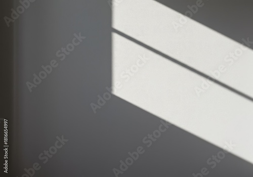 Abstract composition featuring stark sunlight casting sharp geometric shadows across a textured white wall. Clean contemporary design element ,contemporary ,light ,urban