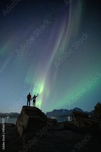 Couple enjoying a night under the Northern Lights in Tromso, Norway