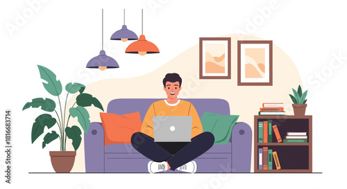 Happy young man sits cross-legged on a cozy sofa with a laptop working or studying from the comfort of his modern home.