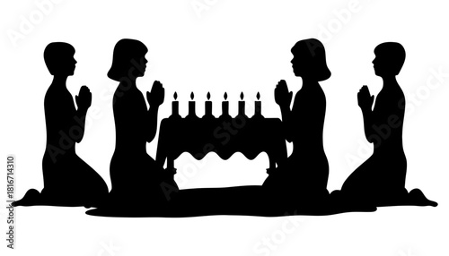 Silhouette of people praying with candles for religious art