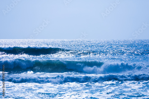 Fototapeta Naklejka Na Ścianę i Meble -  A beautiful seascape in blue tones. Ocean waves and sea foam against a backdrop of blue water
