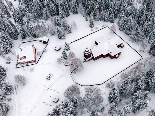 Aerial winter landscape with the wooden articular church of Svaty Kriz and snowy countryside in the Liptov region