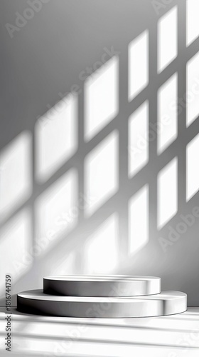 A minimalist scene featuring two circular white pedestals of different heights, set against a plain wall. Sunlight casts a geometric pattern of diamond-shaped s