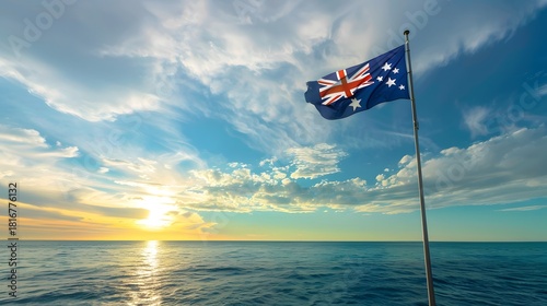Australian flag waves over the ocean at sunset image