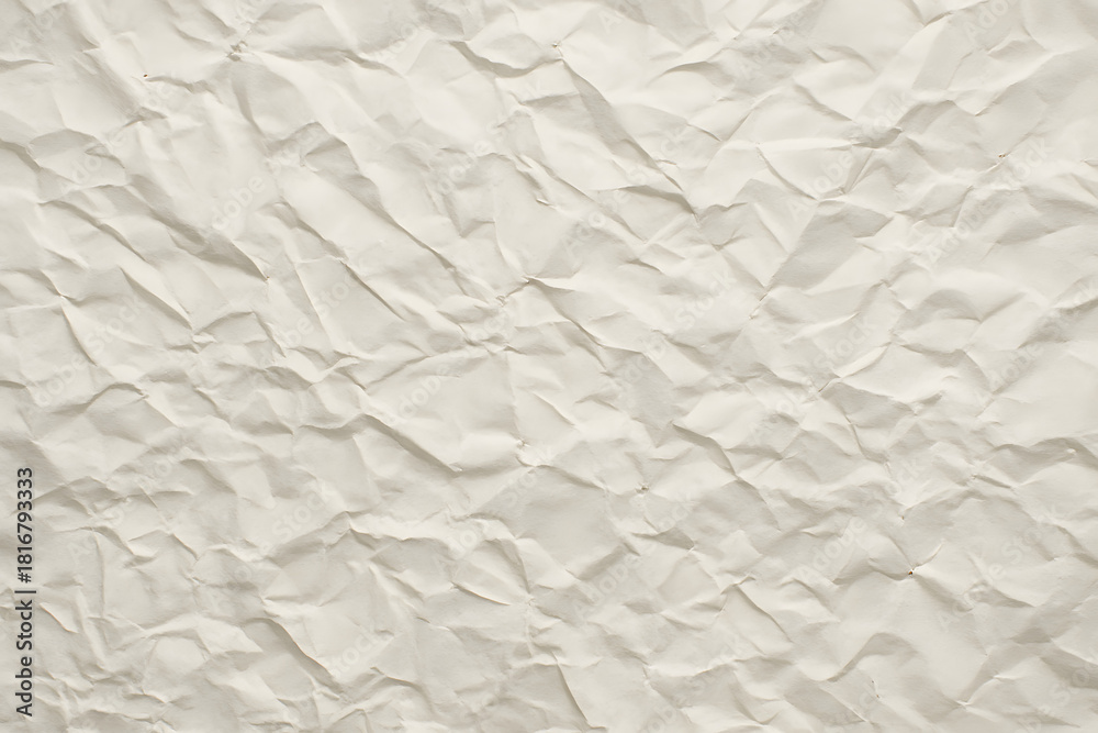 Obraz premium Beige crumpled paper full of texture and folds