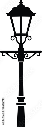 Classic black silhouette of an ornate vintage street lamp with decorative scrollwork on a clean white background representing historical lighting and urban design elements