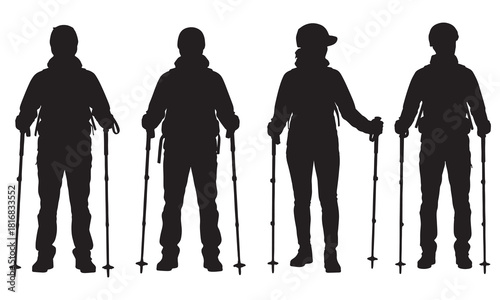 Four hikers with trekking poles standing together in a group silhouette