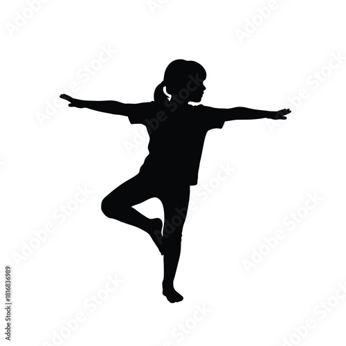 Child performing yoga tree pose silhouette