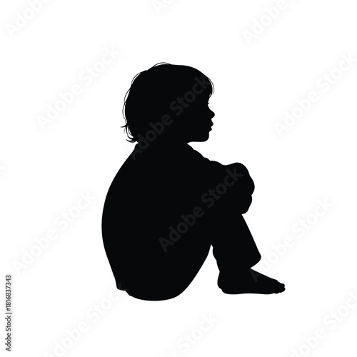 Child sitting in contemplative silhouette