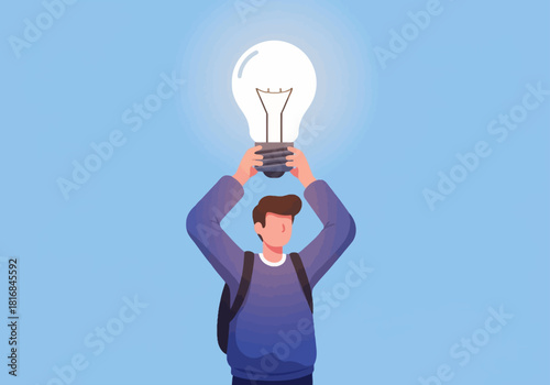 Young man holding a glowing light bulb high, representing successful idea, innovation, creative solution, and breakthrough inspiration concept.