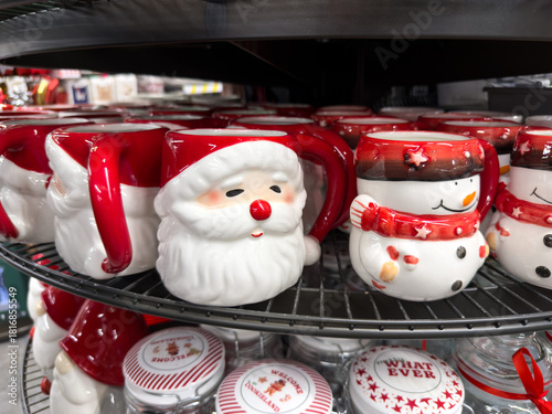 Cheerful ceramic Santa Claus and snowman mugs displayed on a store shelf, perfect for festive holiday gift giving and warm winter celebrations