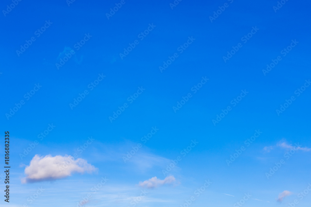 Fototapeta premium small clouds in clear blue sky on sunny autumn day